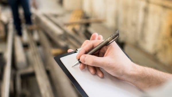 Ag Bag Quality Control person writing on clipboard